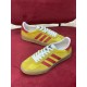 Top-down view of Gucci yellow velvet Gazelle low top trainers in yellow and red