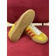Underside view showing translucent gum sole tread of Gucci Gazelle trainer in yellow and red