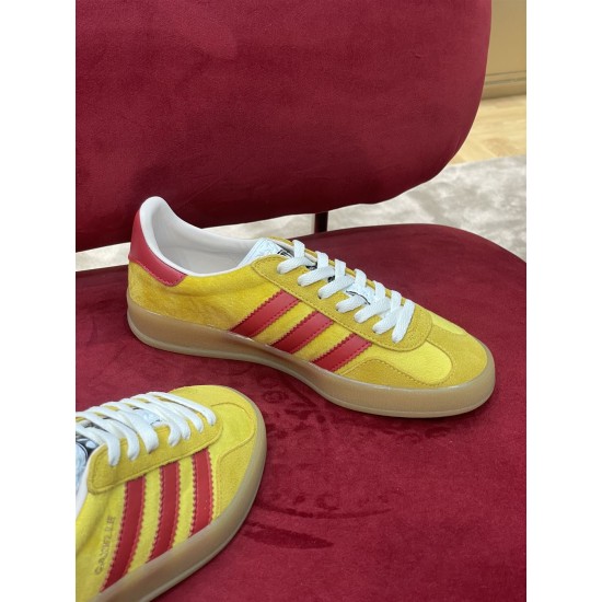 Side profile angle of yellow and red Gucci velvet Gazelle trainer