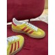 Side profile angle of yellow and red Gucci velvet Gazelle trainer