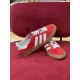 Gucci Gazelle Red Velvet Trainer Angled Pair in red and white Gucci Gazelle red trainer resting at an angle on another trainer in red and white