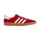 Gucci Gazelle Red Velvet Trainer Profile View in red and white Profile view of Gucci Gazelle red velvet low-top trainer with white stripes and gum sole on white background