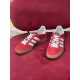 Gucci Gazelle Red Velvet Trainers Front Angle in red and white Front elevated view of red velvet Gucci Gazelle trainers displaying white laces and toe cap