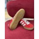 Gucci Gazelle Red Velvet Trainer Sole View in red and white Underside of gum rubber tread on Gucci Gazelle trainer shown next to upper in red and white