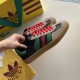 Gucci Gazelle Trainers Pair Overview in black and red Pair of Gucci Gazelle black leather trainers held in hand displaying green and red side stripes