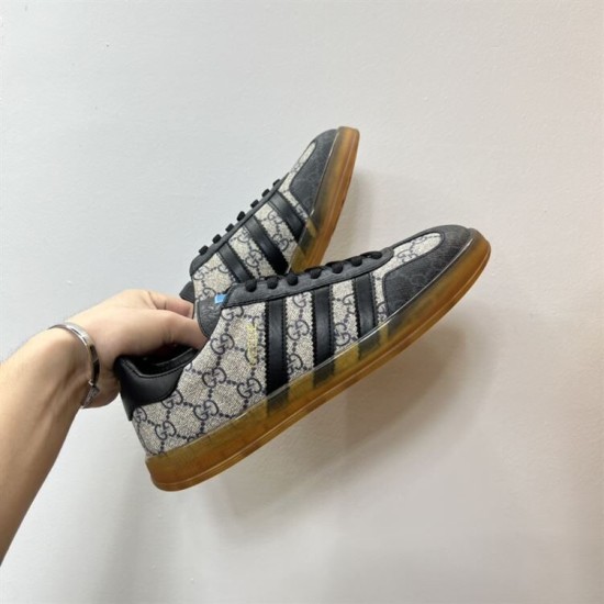 Handheld view of Gucci Men's Gazelle Monogram Canvas Low-Top Trainers at dynamic angle in beige and black