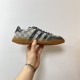 Profile shot of Gucci Men's Gazelle Monogram Canvas Low-Top Trainer held against wall in beige and black