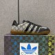 Gucci Men's Gazelle Monogram Canvas Low-Top Trainer sitting on branded shoebox in beige and black