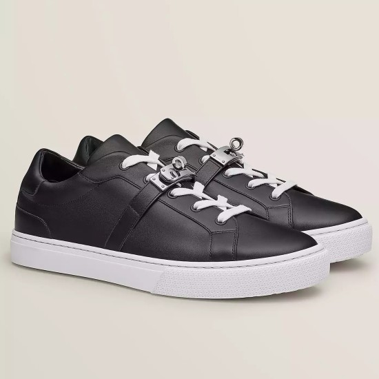 Hermes Day Black Leather Low Top Trainers Side View in black and white Side studio view of Hermes Day black leather low top trainers with white soles