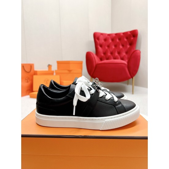 Hermes Day Black Leather Trainers Profile View in black and white Side profile of Hermes Day black leather trainers sitting on an orange box in black and white