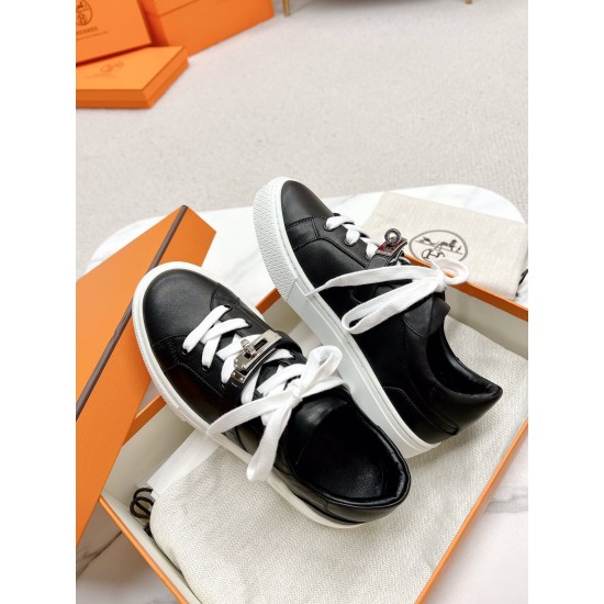 Hermes Day Black Leather Trainers in Packaging in black and white Pair of Hermes Day black leather trainers resting inside an open orange shoe box in black and white
