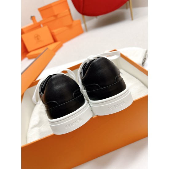 Hermes Day Black Leather Trainers Heel Detail in black and white Rear heel view showing debossed brand lettering on the white rubber sole of black leather trainers