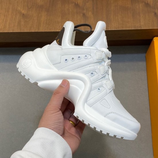 L Archlight chunky white sneaker side view with wave sole and monogram detail in white and brown Side profile of L Archlight chunky white sneaker showing oversized wave sole and brown monogram heel tab