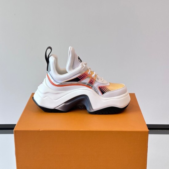 Side View of White L Archlight Sneaker with Sculptural Sole in white and orange Side profile of the white L Archlight Sneaker showcasing the oversized arch sole and orange accents