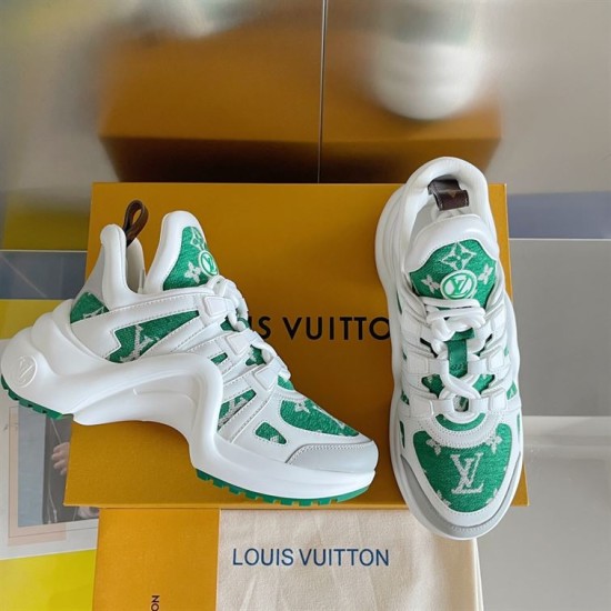 Angled View of L Archlight Green and White Footwear Angled view showing green and white trainers beside packaging