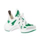 Studio Shot of L Archlight Green and White Trainers Studio shot of green and white trainers on a plain background