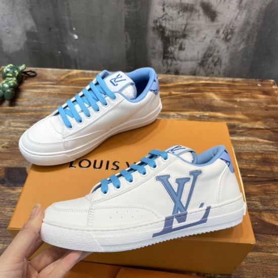 L Charlie Low Top Leather Blue Accent Trainers Pair View in blue and white L Charlie Low Top Leather Blue Accent Trainers paired perspective on wooden surface in blue and white