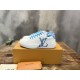 L Charlie Low Top Leather Blue Accent Trainers Angled View in blue and white L Charlie Low Top Leather Blue Accent Trainers angled view resting on an orange box in blue and white