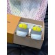 Rear View of L Charlie Trainers with Yellow Heel Tabs in white Rear view of two L Charlie trainers showing white rubber soles and yellow heel counters