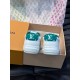 L Charlie Low Top Leather Trainers In White And Green - Rear View Rear view of L white and green leather trainers displaying embossed midsole branding