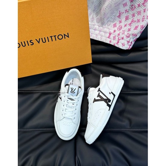 L Charlie White Trainers Overhead Pair View Pair of L Charlie white low top trainers resting on a dark surface beside a brand box