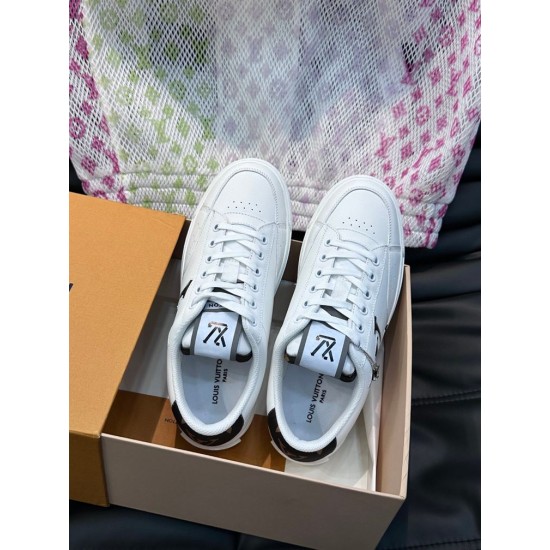 L Charlie White Trainers in Packaging Pair of white L Charlie low top trainers inside open shoe box showing clean toe design