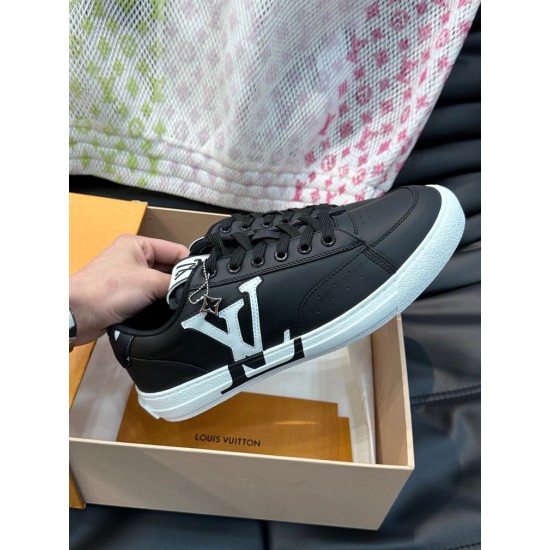 L Charlie Monogram Leather Low-Top Trainers Black White held up in hand