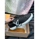 L Charlie Monogram Leather Low-Top Trainers Black White held up in hand