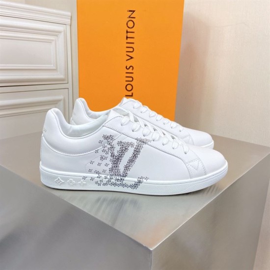 L White Leather Low Top Trainers with Packaging Box L white leather low top trainers displayed on a grey surface in front of an orange box