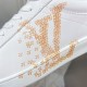 L classic white leather trainers with gold motif accent close-up detail L classic white leather trainers with gold motif accent close-up of the gold side pattern