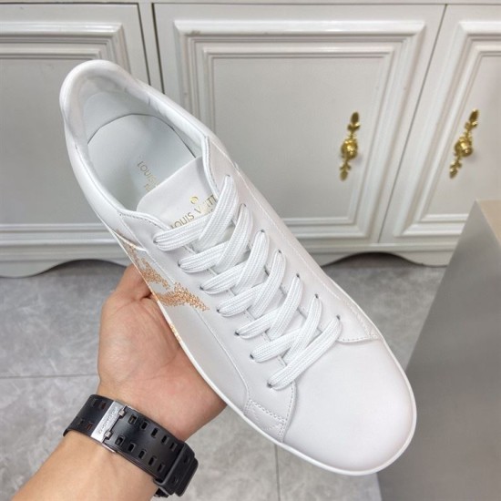 L classic white leather trainers with gold motif accent top down view L classic white leather trainers with gold motif accent overhead look at laces and tongue