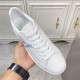 L Classic Leather Trainers Handheld View in white and blue L white trainers held in hand showing tongue and branding in white and blue