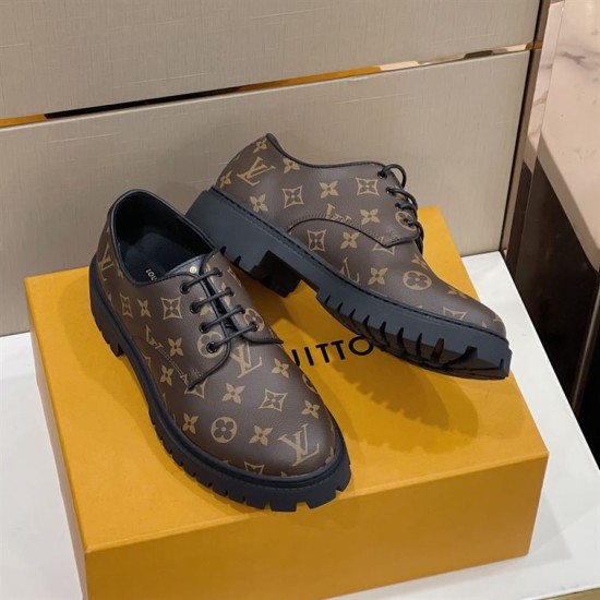 L Monogram Canvas Derby Shoes In Brown Paired Display in brown and black Pair of brown monogram Derby shoes resting on a branded orange box in brown and black