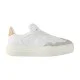 L White Embossed Monogram Trainers Studio Profile in white and beige Studio side profile of L white embossed monogram trainers against a clean background in white and beige