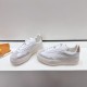 L White Trainers Front Three Quarter View in white and beige Front three-quarter view of L white trainers featuring suede toe caps in white and beige