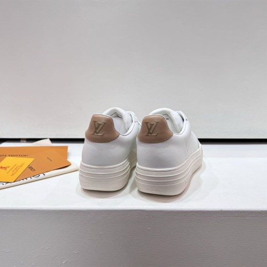 L White Trainers Rear Heel View in white and beige Rear view of L white trainers showing beige heel counters and branding