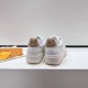 L White Trainers Rear Heel View in white and beige Rear view of L white trainers showing beige heel counters and branding