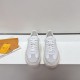 L White Trainers Top Down View in white and beige Top-down view of L white trainers showcasing laces and tongue branding in white and beige