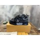 Side profile of black L skate shoes trainer resting on a branded box Side profile of black L skate shoes trainer resting on a branded box