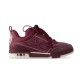 Studio profile view of L Skate burgundy leather low top trainers in burgundy and white