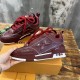 Outer side perspective of L Skate burgundy leather low top trainers in burgundy and white