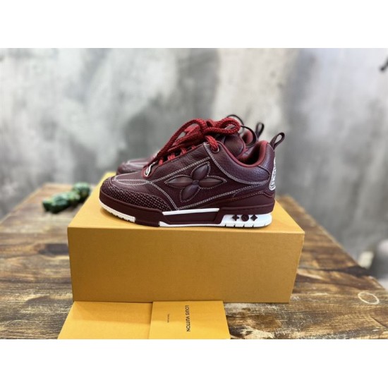 Side angle of L Skate burgundy leather low top trainers next to branded box in burgundy and white