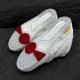 Underside sole view of L Skate Leather Trainers in white and red with grip patterns