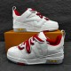 Pair of L Skate Leather Trainers in white and red presented on an orange box