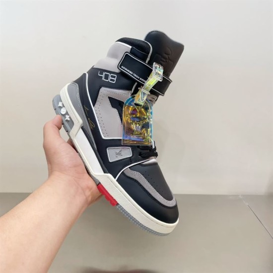 L Trainer high top leather sneaker in black and grey held in hand lateral view