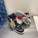 Pair of L Trainer high top leather sneakers showing rubber sole tread detail in black and grey