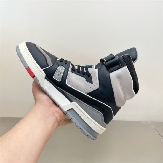 L Trainer high top leather sneaker in black and grey held in hand medial view