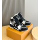 L High Top Trainer Leather Sneakers In Black And White - Dual Angle Pair Angled perspective of a pair of black and white L high top trainers resting on an orange box