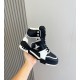 L High Top Trainer Leather Sneakers In Black And White - Lateral Handheld View Handheld lateral view of the black and white L high top trainer highlighting the upper panels