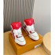 Pair of L Trainer high top sneakers in red and white placed on a presentation box